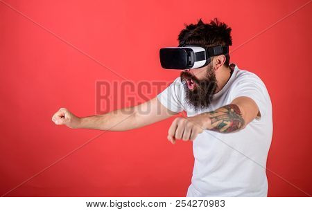 Man With Beard In Vr Glasses Driving Motorbike, Red Background. Hipster On Shocked Face Driving Bike