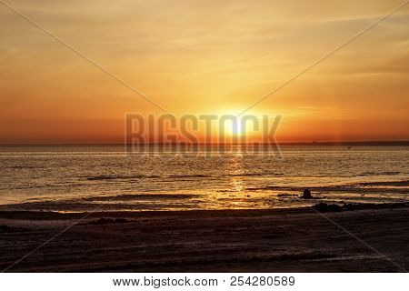 Beautiful Sunset Over The Sea. The Sun Sets On The Water. The Sky Is Painted With Bright Colors. Sum