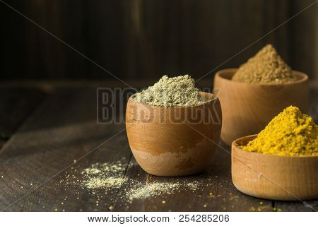 Heaps Of Various Ground Spices On Wooden Background. Georgian Spices, Indian Spices, Arabian Spices.