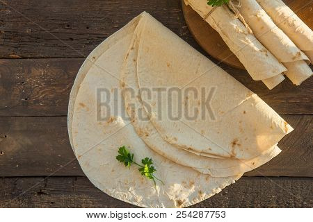 Armenian Flat Bread Lavash. Pita Bread On Black Cwood Background. Copy Space.