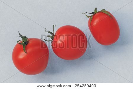 Set Of Three Red Tomatoes Isolated On White Background