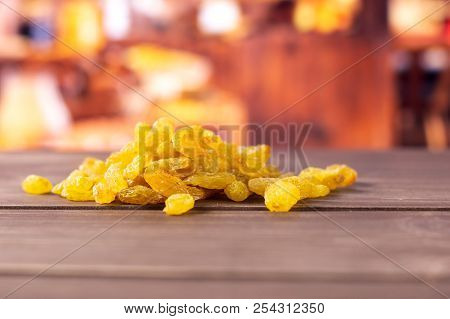 Lot Of Whole Dry Golden Raisins Sultana Variety Heap With Rustic Wood Kitchen In Background