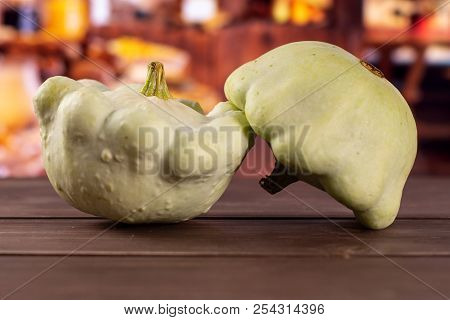 Group Of Two Whole Fresh Summer White Pattypan Squash With Rustic Wood Kitchen In Background