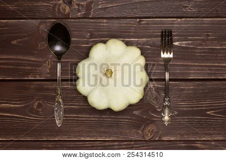 One Whole Summer White Pattypan Squash With Fork And Spoon Flatlay On Brown Wood