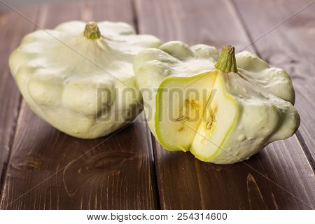 Group Of Two Whole Summer White Pattypan Squash One Sliced On Brown Wood