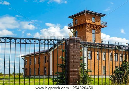 Fire Tower. Ancient Central Fire Tower And Fire Station Building. Metal Fence.