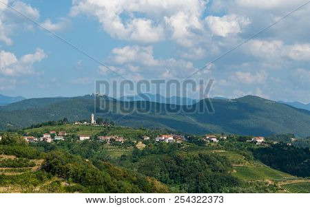 Village Of Kojsko, Sloveniain Famous Wine Growing Region Of Goriska Brda, Lit By Sun And Clouds In B