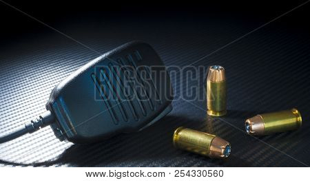 Center Fire Ammunition For A Handgun With A Microphone On Dark Background