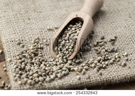Hemp Seeds In A Rustic Wooden Spoon On The Burlap Napkin, Space For Text