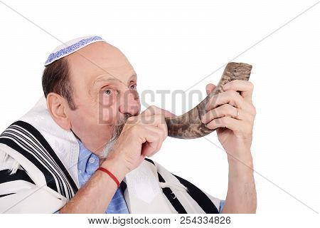 Eldery Jewish Man Blowing The Shofar Horn For The Jewish New Year Holiday (rosh Hashanah). Religion 