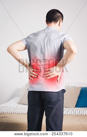 Back Pain, Kidney Inflammation, Man Suffering From Backache At Home, Painful Area Highlighted In Red