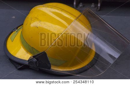 A Close Up Side View Of A Yellow Firefighters Helmet