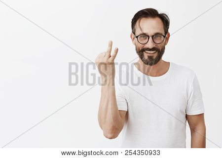 Two Reasons Why I Like You. Studio Shot Of Charming Happy And Carefree Adult Man In Glasses And T-sh