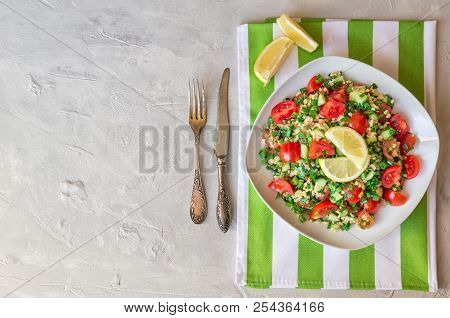 Tabbouleh (tabouli) Salad On A Dish On Light Gray Concrete Background. Healthy Vegetarian Food. Leba