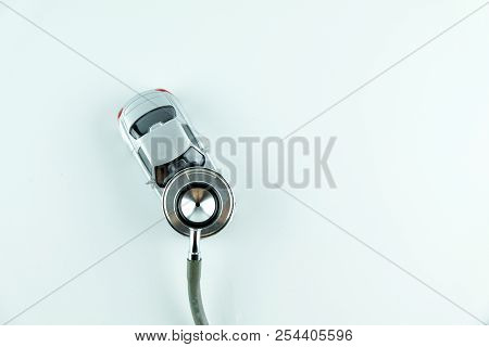 Stethoscope Checking Up The Car On White Background, Concept Of Car Check Up, Repair And Maintenance