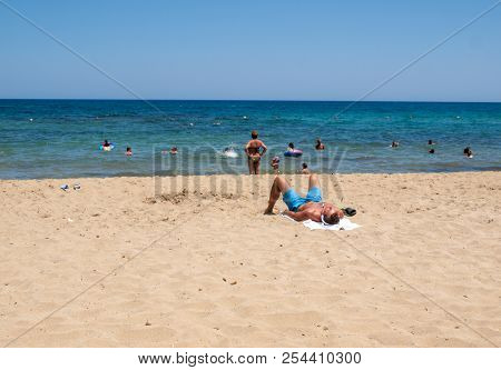 Malia, Crete, Greece - July 1, 2018: People Are Resting On A Sunny Day At The Beach In Malia, Crete,