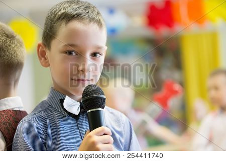 Belarus, Gomel, May 24 2018. The Kindergarten Is Central. Open Day.boy Preschooler With Microphone.a