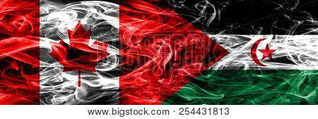 Canada Vs Sahrawi Smoke Flags Placed Side By Side. Canadian And Sahrawi Flag Together