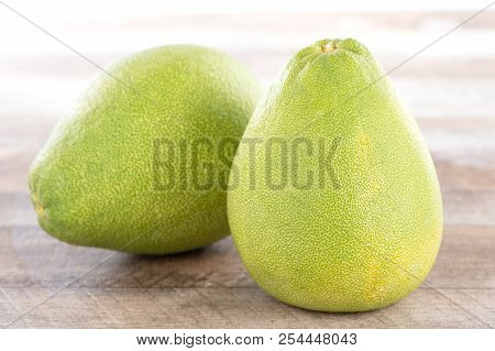 Fresh And Peeled Pomelo(shaddock), Grapefruit With Slices On Wooden Table Background