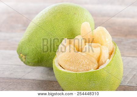 Fresh And Peeled Pomelo(shaddock), Grapefruit With Slices On Wooden Table Background