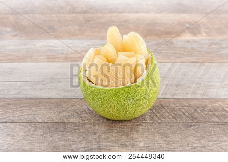 Fresh And Peeled Pomelo(shaddock), Grapefruit With Slices On Wooden Table Background