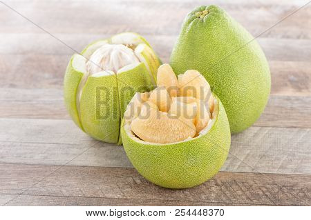 Fresh And Peeled Pomelo(shaddock), Grapefruit With Slices On Wooden Table Background