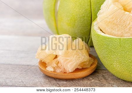 Fresh And Peeled Pomelo(shaddock), Grapefruit With Slices On Wooden Table Background