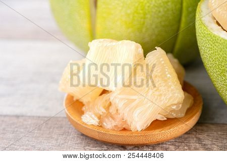 Fresh And Peeled Pomelo(shaddock), Grapefruit With Slices On Wooden Table Background
