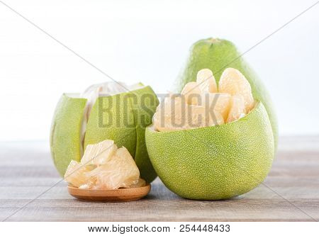 Fresh And Peeled Pomelo(shaddock), Grapefruit With Slices On Wooden Table Background