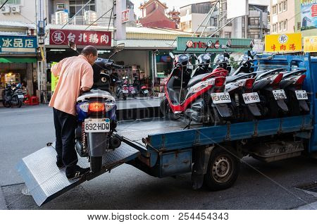 20 February 2018, Tainan Taiwan: Streetview Of Man Putting A Scooter In A A Truck Full Of Scooters I