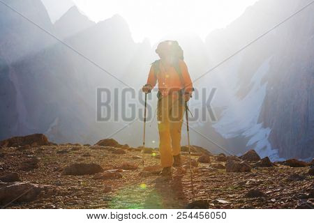 Wanderlust time. Man hiking in beautiful Fann mountains in Pamir, Tajikistan. Central Asia.