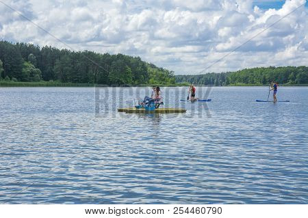 Zhytomyr, Ukraine - July 16, 2018. Athletes Conduct Training On High-speed Swimming Kayak (kayaking)