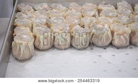 Blurry Image Of Man Or Chef Is Making Dim Sum. By Dumpling Wrappers.