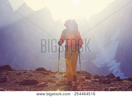 Wanderlust time. Man hiking in beautiful Fann mountains in Pamir, Tajikistan. Central Asia.