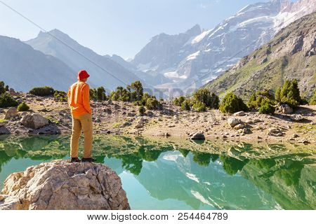 Wanderlust time. Man hiking in beautiful Fann mountains in Pamir, Tajikistan. Central Asia.