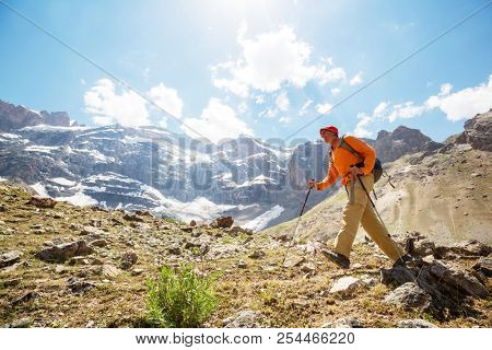 Wanderlust time. Man hiking in beautiful Fann mountains in Pamir, Tajikistan. Central Asia.