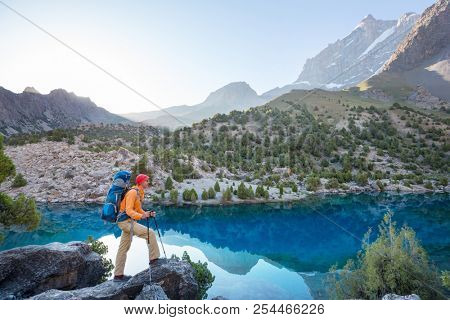 Wanderlust time. Man hiking in beautiful Fann mountains in Pamir, Tajikistan. Central Asia.