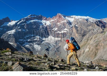 Wanderlust time. Man hiking in beautiful Fann mountains in Pamir, Tajikistan. Central Asia.