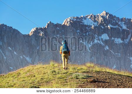Wanderlust time. Man hiking in beautiful Fann mountains in Pamir, Tajikistan. Central Asia.