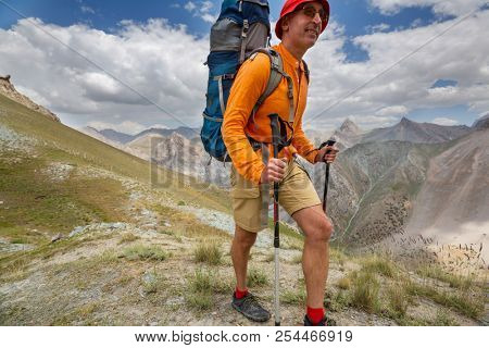 Wanderlust time. Man hiking in beautiful Fann mountains in Pamir, Tajikistan. Central Asia.