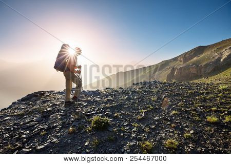 Wanderlust time. Man hiking in beautiful Fann mountains in Pamir, Tajikistan. Central Asia.