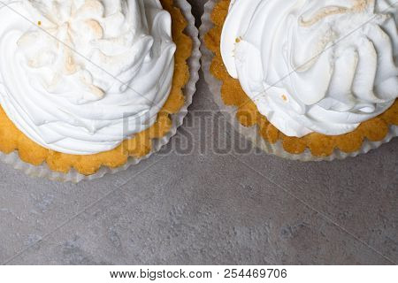 Delicious Merengue Dessert. Lemon Tartlet Tart With With Meringue On Grey Stone Concrete Table Backg