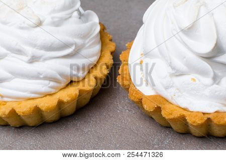 Delicious Merengue Dessert. Lemon Tartlet Tart With With Meringue On Grey Stone Concrete Table Backg