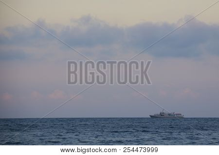 Ship In The Sea At Sunset. Summer Beautiful Sunset On The Black Sea, The Ship Is Floating In The Dis