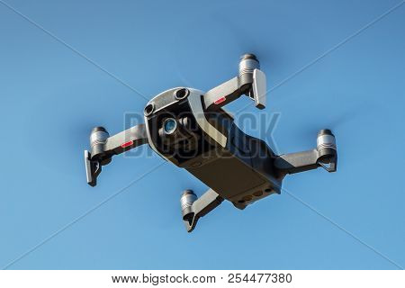 Drone With Propellers Flies In Sky And Photographs Landscapes