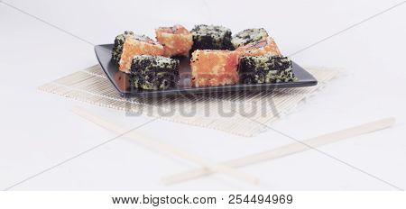 Different Types Of Maki Sushi On A Black Plate