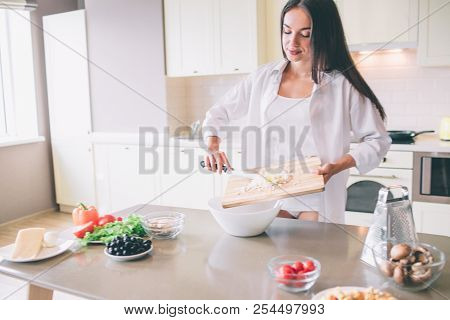 Concentrated Girl Is Cooking Breakfst. She Is Putting Cheese Into Bowl. Girl Looks Concentrated And 