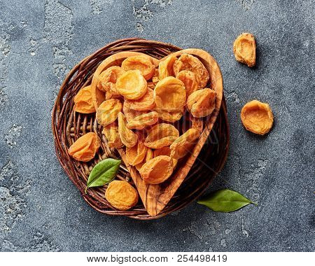 Dried Apricots On Gray Concrete Background. Top View.