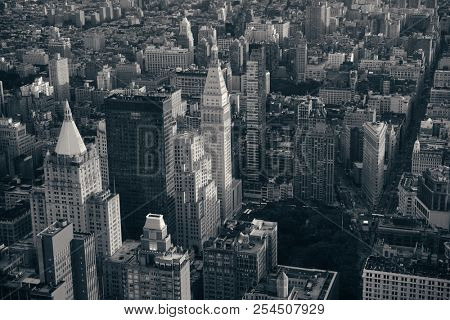 New York City rooftop view with downtown Manhattan skyscrapers and urban cityscape.