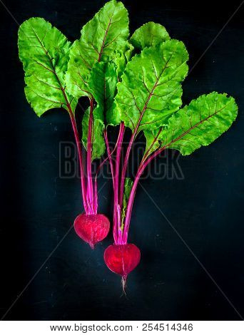 Beetroot Cut In Half On A Black Background, Place For Text, Healthy Food Copy Space. Top View.
